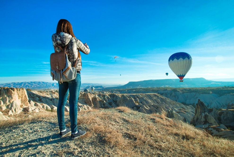 female-tourist-taking-photos-hot-air-balloon-cappadocia_192787-155